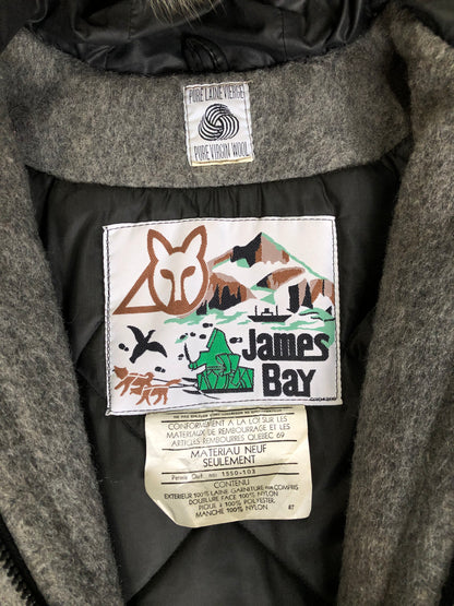 Kingspier Vintage - James Bay pure virgin wool northern parka in grey. This parka features a hood with white fur trim, zipper closure, quilted lining, knit inside hidden cuffs, patch pockets, felt deer appliqués on the front and on the sleeves. Made in Canada.