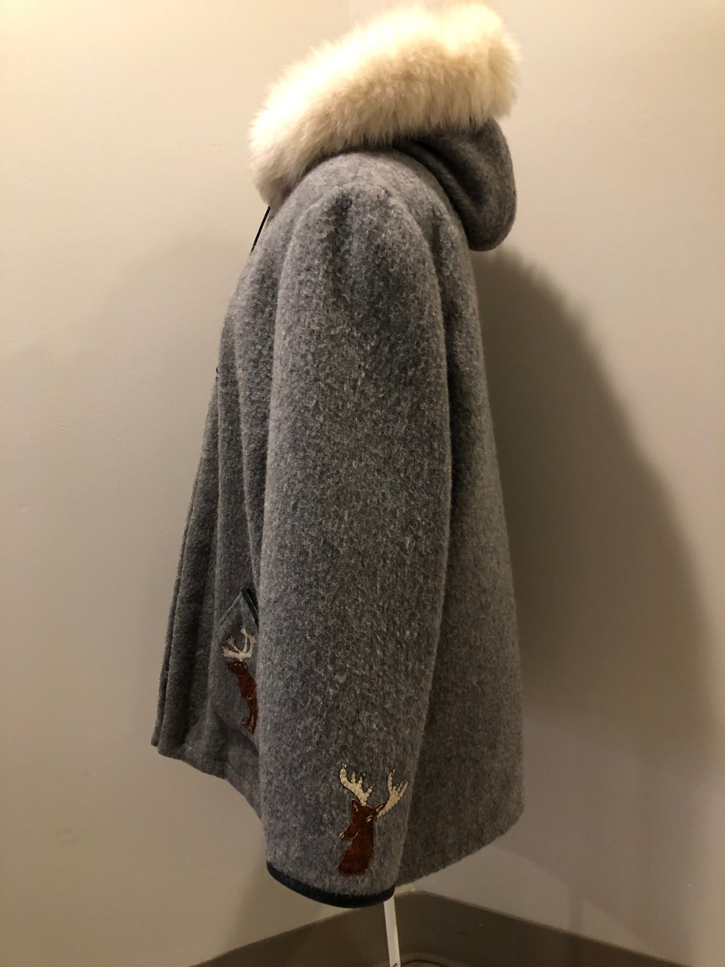 Kingspier Vintage - James Bay pure virgin wool northern parka in grey. This parka features a hood with white fur trim, zipper closure, quilted lining, knit inside hidden cuffs, patch pockets, felt deer appliqués on the front and on the sleeves. Made in Canada.