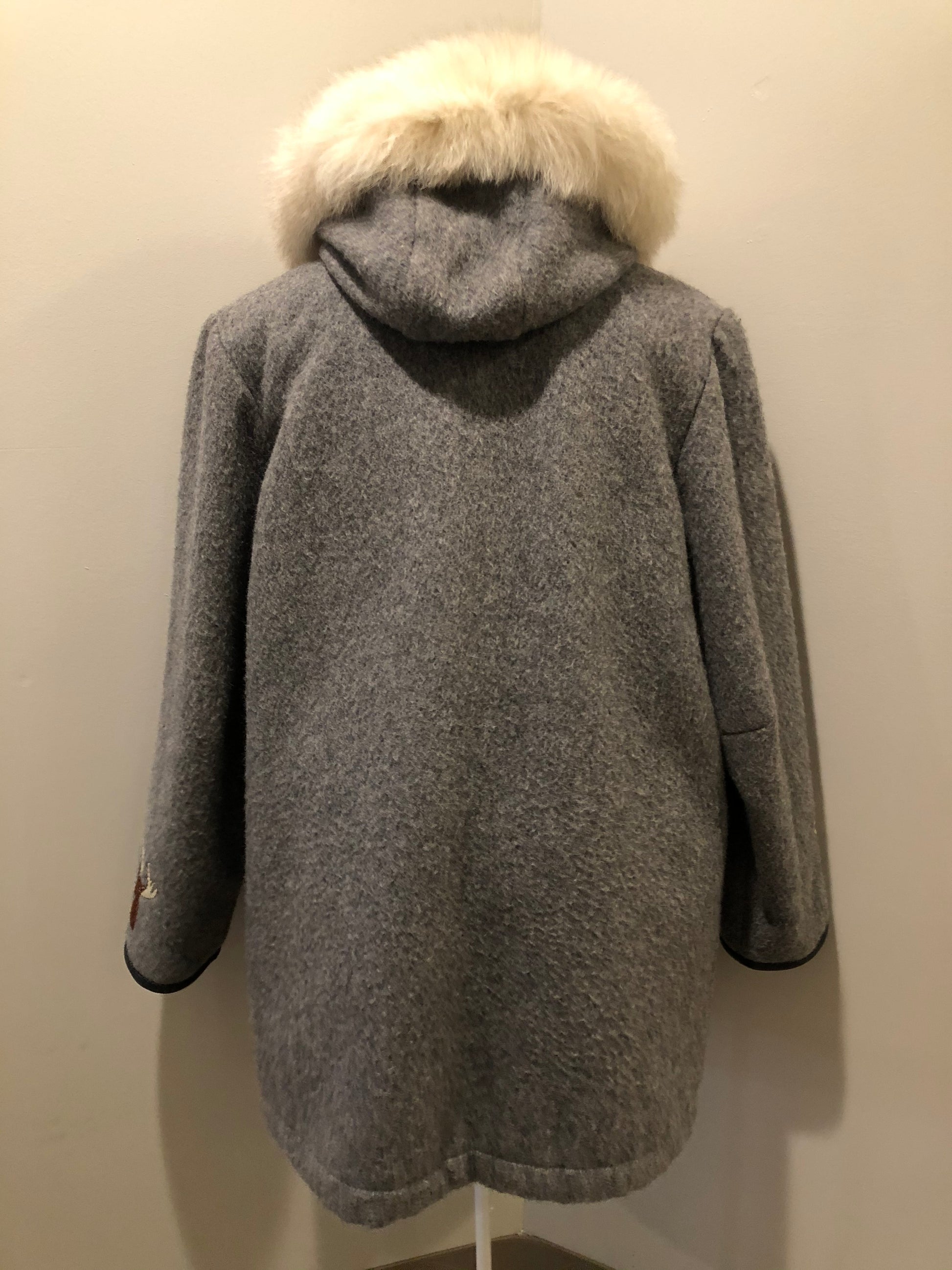 Kingspier Vintage - James Bay pure virgin wool northern parka in grey. This parka features a hood with white fur trim, zipper closure, quilted lining, knit inside hidden cuffs, patch pockets, felt deer appliqués on the front and on the sleeves. Made in Canada.