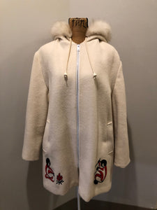 Kingspier Vintage - Canadian Sportswear pure virgin wool northern parka in cream. This parka features a hood with white fur trim, zipper closure, quilted lining, slash pockets, felt fire making design appliqués on the front and canoeing scene design on the back. Made in Canada.