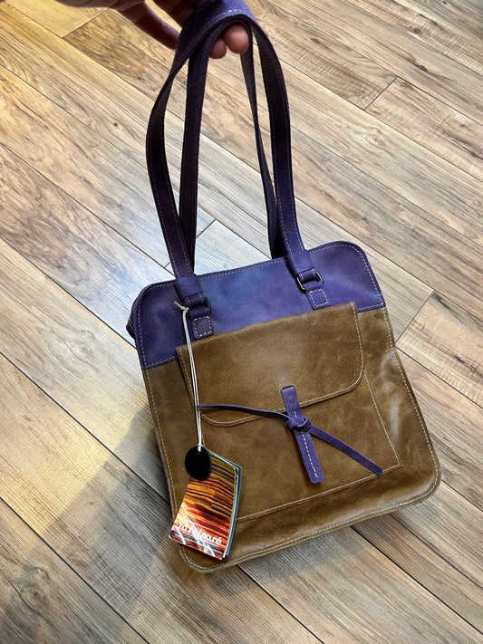 Yoreinare brown and purple leather handbag with zip closure, one pocket inside the main compartment and one small pocket on the front and back.

New with tags
Made in Columbia