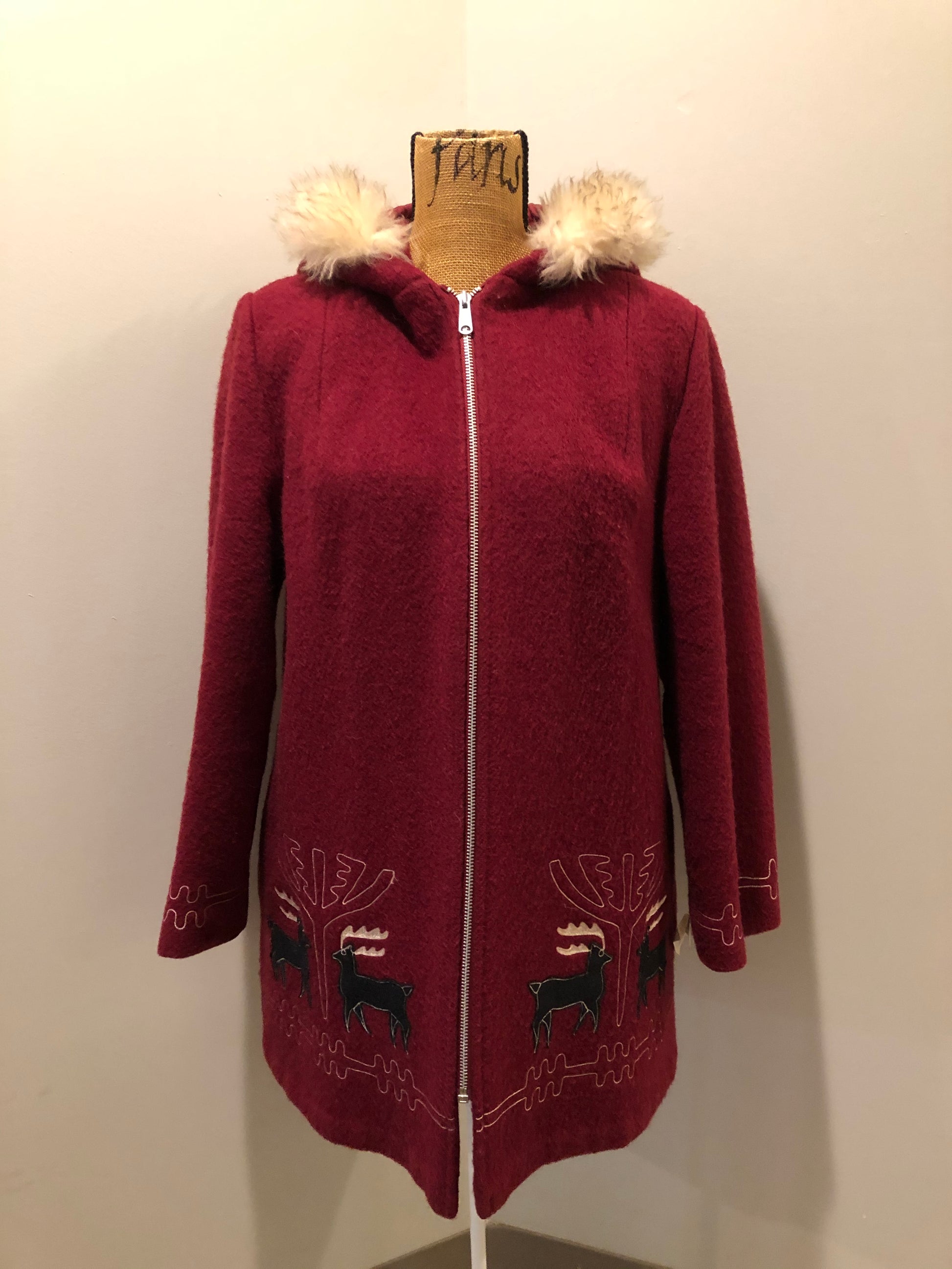 Kingspier Vintage - Sears pure virgin wool northern style parka in raspberry red. This parka features a hood with white faux fur trim, zipper closure, quilted lining, vertical pockets, hidden elastic in the lining at the wrist to keep out cold air, felt deer design appliqués on the front. Made in Canada.