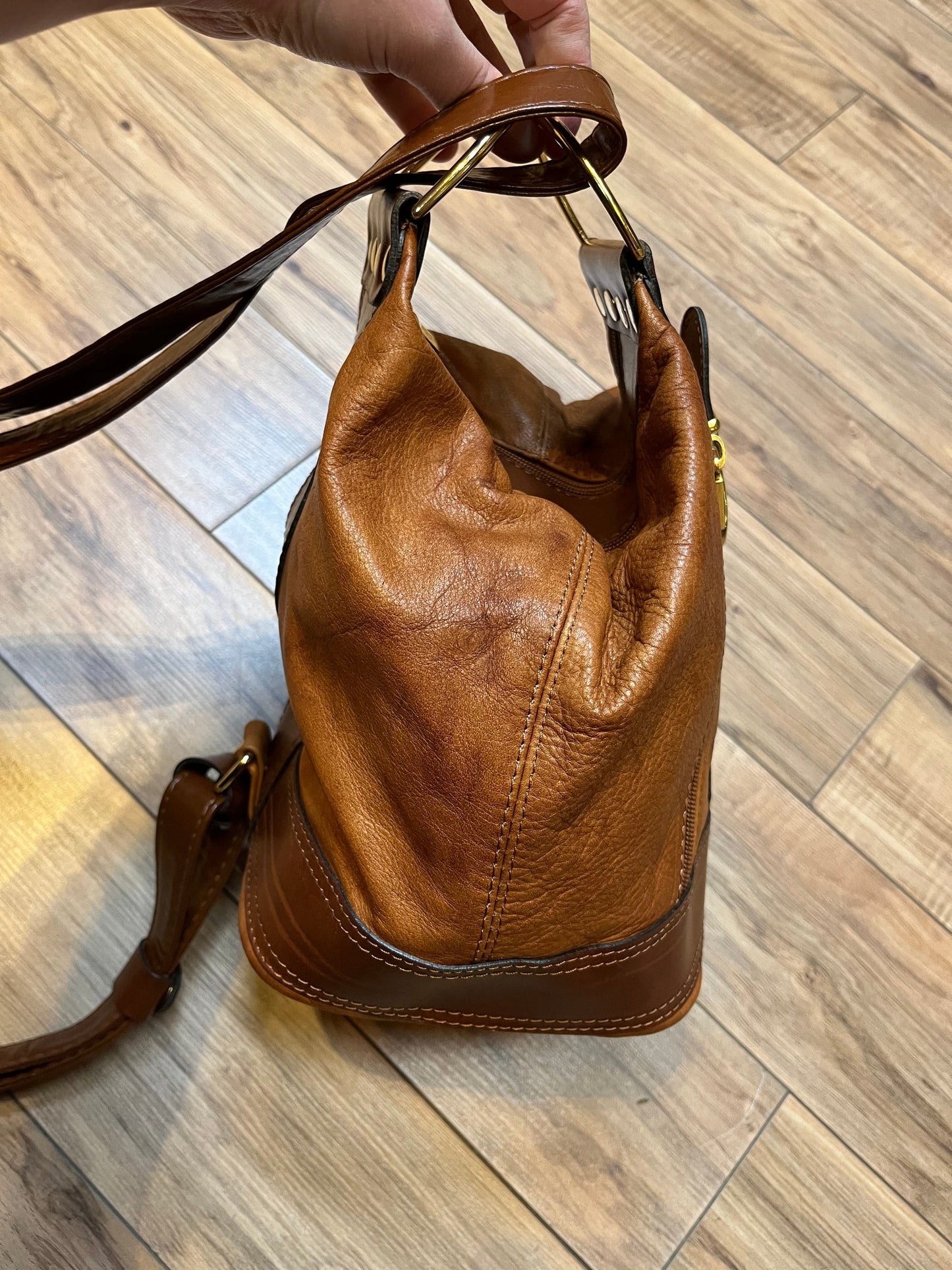 Vintage Valentino Di Paolo brown leather bucket bag/ knapsack with brass hardware, multi-pockets and multi- zip.

Made in Italy