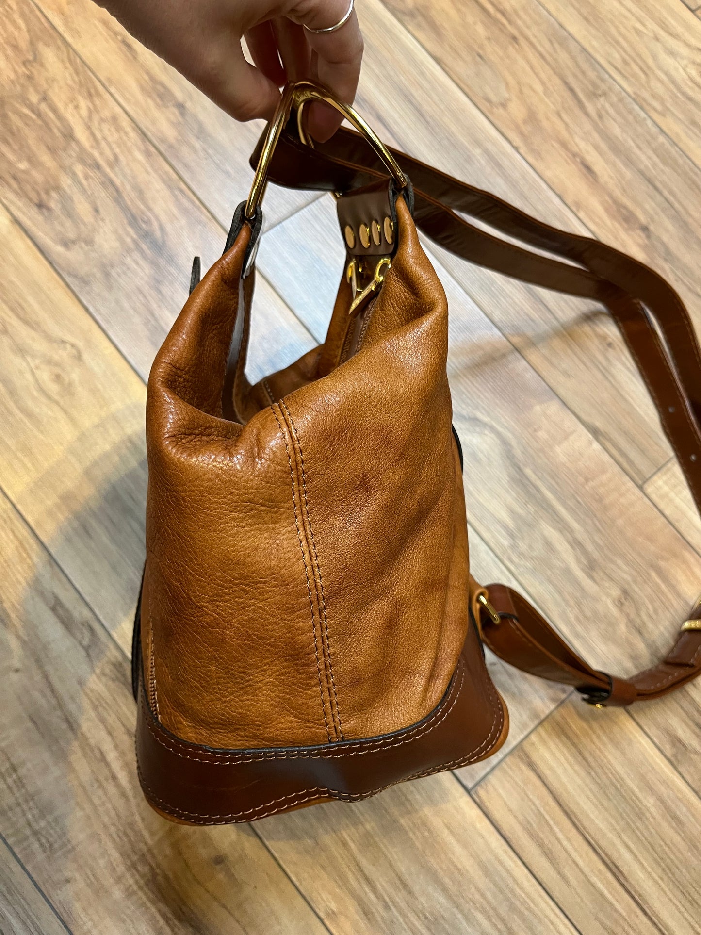 Vintage Valentino Di Paolo brown leather bucket bag/ knapsack with brass hardware, multi-pockets and multi- zip.

Made in Italy