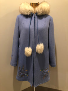Kingspier Vintage - Northern Sun pure virgin wool northern style parka in light blue. This parka features a hood with white fur trim, zipper closure, quilted lining, slash pockets, hidden inside knit cuffs, embroidered geese design on the front and back and boats embroidered on the sleeves. Made in Canada.