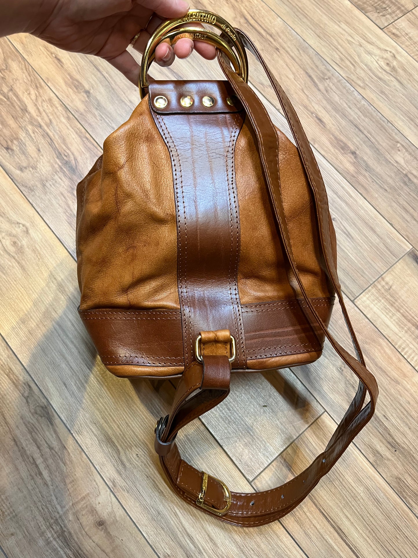 Vintage Valentino Di Paolo brown leather bucket bag/ knapsack with brass hardware, multi-pockets and multi- zip.

Made in Italy