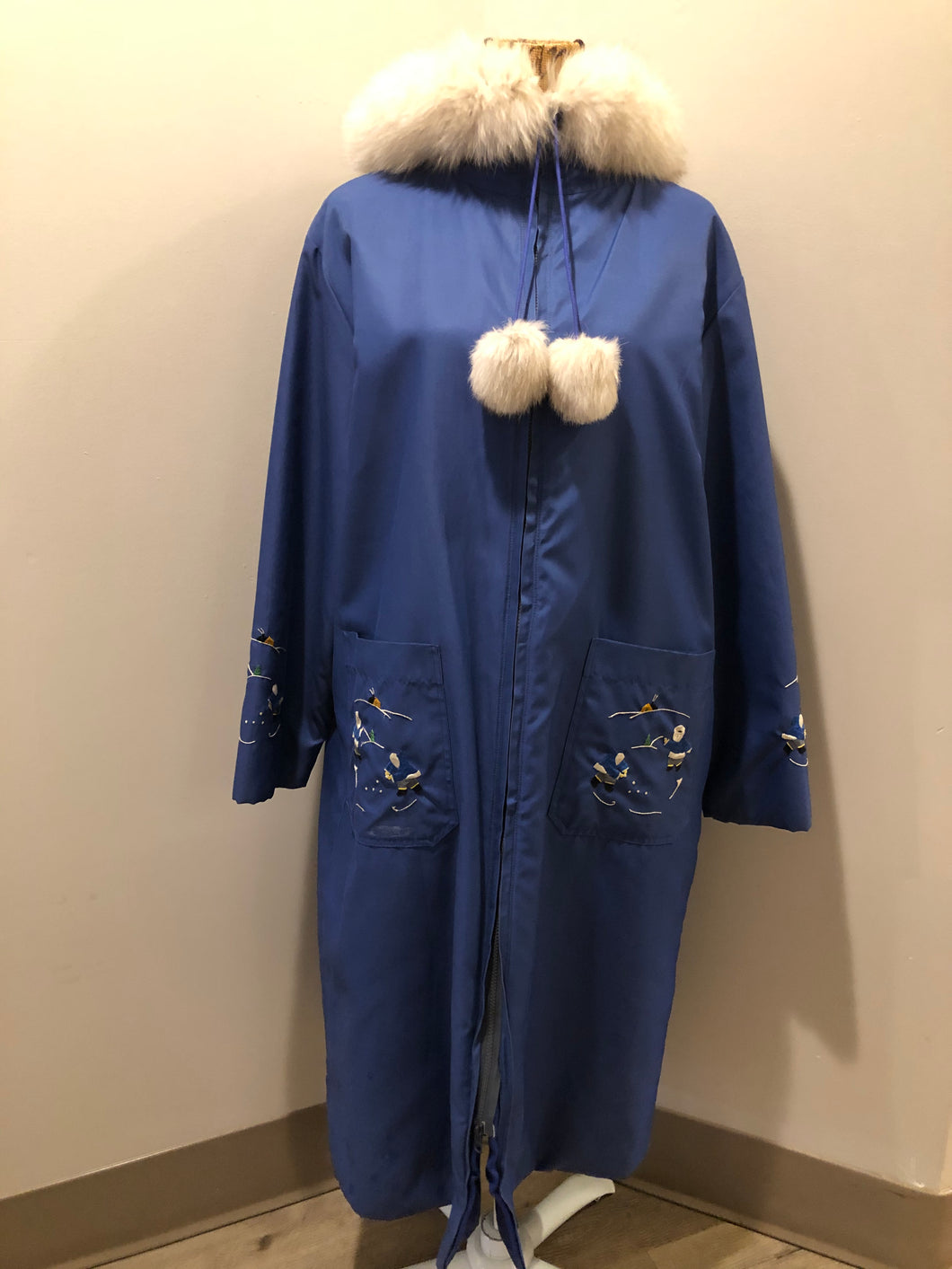 Kingspier Vintage - Blue northern parka made by Marilyn Bessey with wool blend lining, hood with white fur trim, fur Pom poms, zipper closure, patch pockets, arctic life design embroidered on the front pockets and the sleeves. Made in Canada.