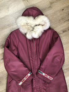 Kingspier Vintage - “Styles North” pink northern parka with removable outer shell featuring a hood with white fur trim, zipper closure, lining, patch pockets, felt warrior appliqué design on the front and back. Made in Canada. 