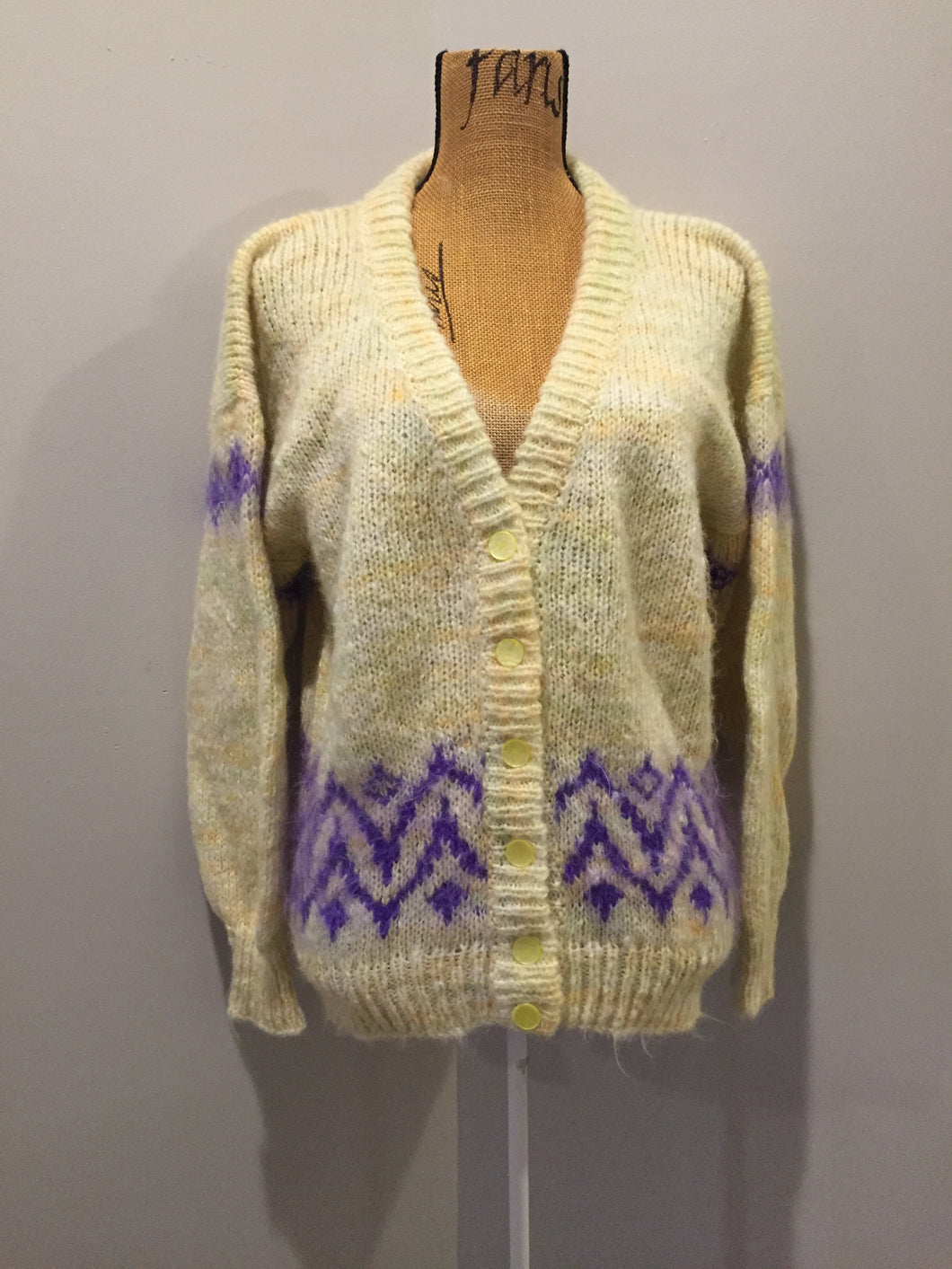 Kingspier Vintage - Hand knit cardigan in pale yellow with purple design and button closures. Size medium.
