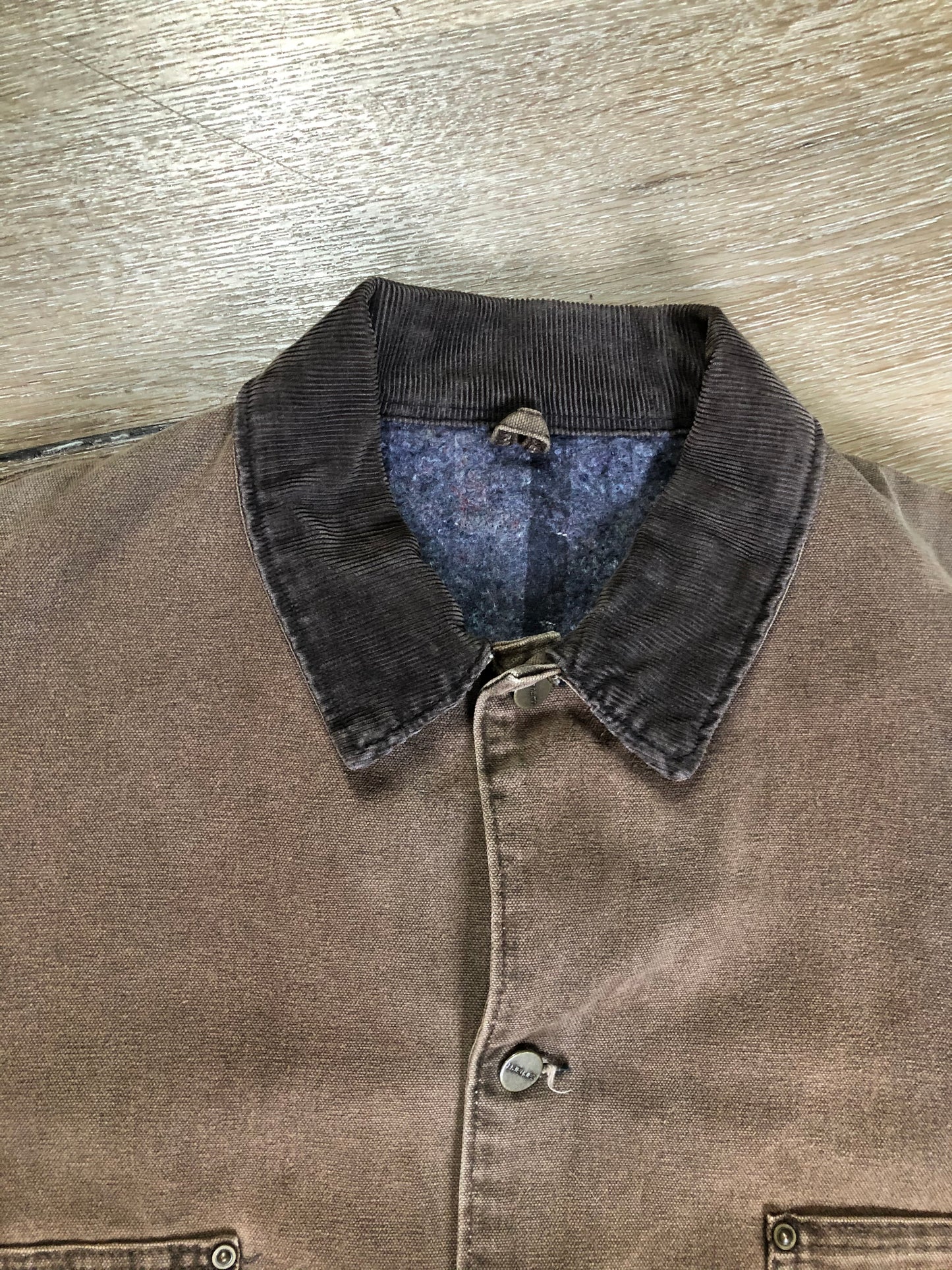 Kingspier Vintage - Carhartt brown chore jacket with brown corduroy collar, button closures, four patch pockets and a felted wool inside lining. Size XL