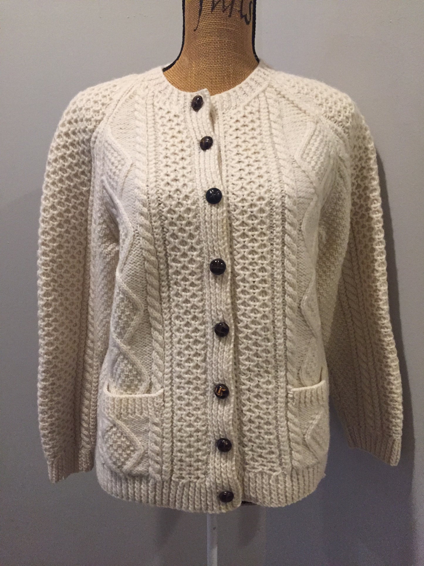 Kingspier Vintage - Vintage hand knit honeycomb and diamond stitch cardigan in white with crew neck, button closures and patch pockets. Size medium.