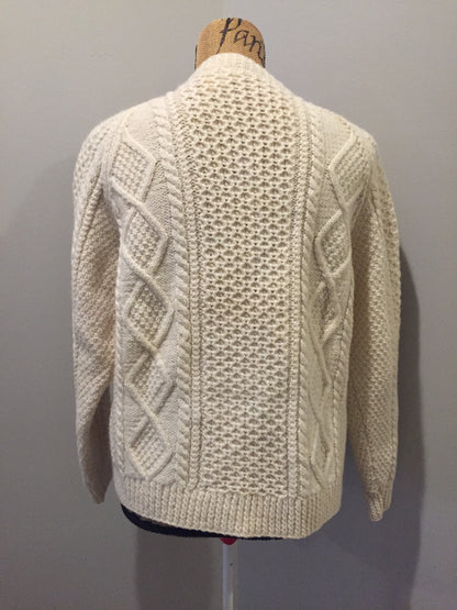 Kingspier Vintage - Vintage hand knit honeycomb and diamond stitch cardigan in white with crew neck, button closures and patch pockets. Size medium.