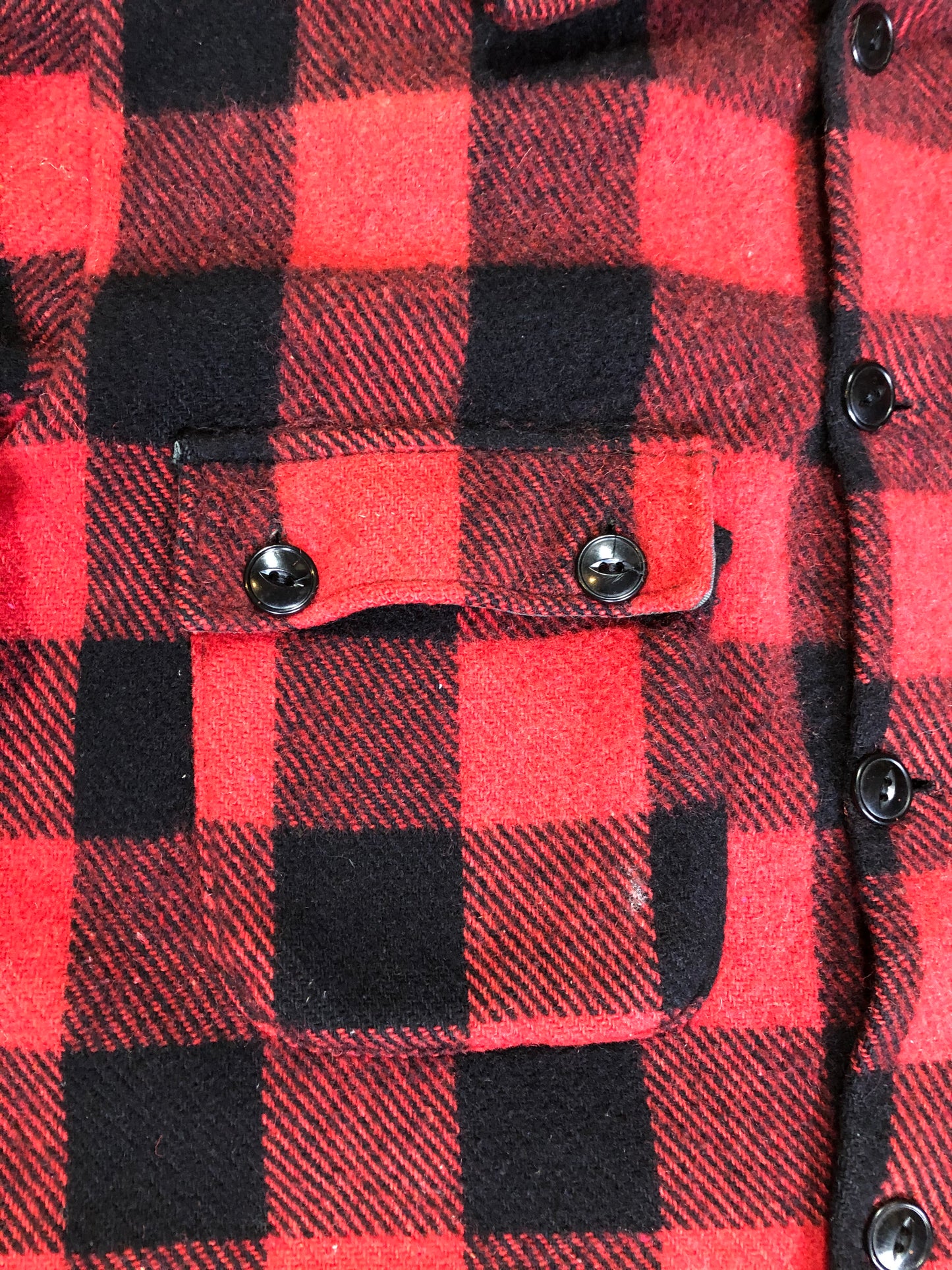 Kingspier Vintage - Sigal red wool blend lumberjack shirt with button closures, two flap pockets, two slash pockets. Made in Canada. Size large.