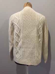 Kingspier Vintage - Vintage hand knit honeycomb and diamond stitch cardigan in white with crew neck, button closures and patch pockets. Size medium.