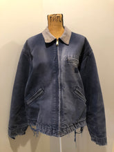 Load image into Gallery viewer, Kingspier Vintage - Carhartt blue canvas chore jacket with beige corduroy collar. The jacket is distressed with frayed edges, wool lining, one zip pocket on the chest and two slash pockets. Made in the USA.
