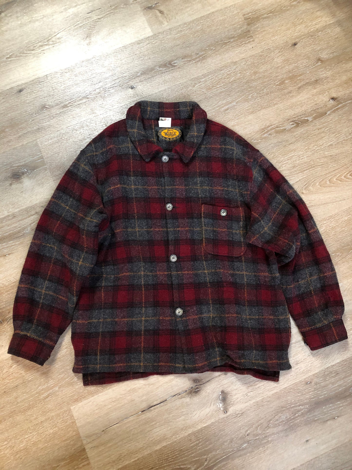 Kingspier Vintage - Woolrich red and grey plaid wool lumberjack shirt with button closures and one patch pocket on the chest.