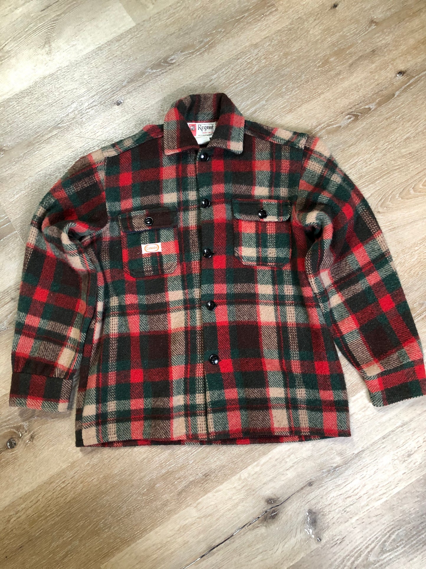 Kingspier Vintage - Regent wool blend lumberjack shirt in green, brown and red plaid with button closures and two flap pockets on the chest. Made in Canada.