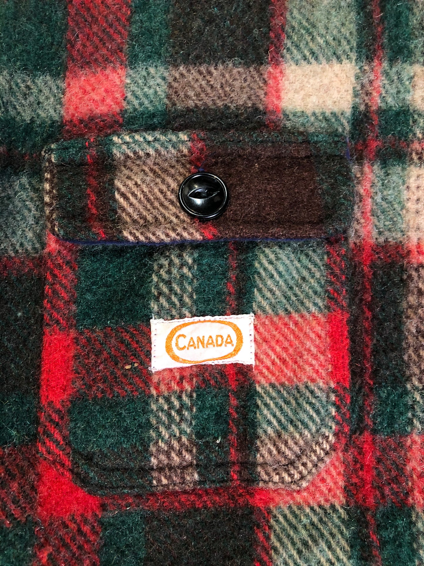 Kingspier Vintage - Regent wool blend lumberjack shirt in green, brown and red plaid with button closures and two flap pockets on the chest. Made in Canada.