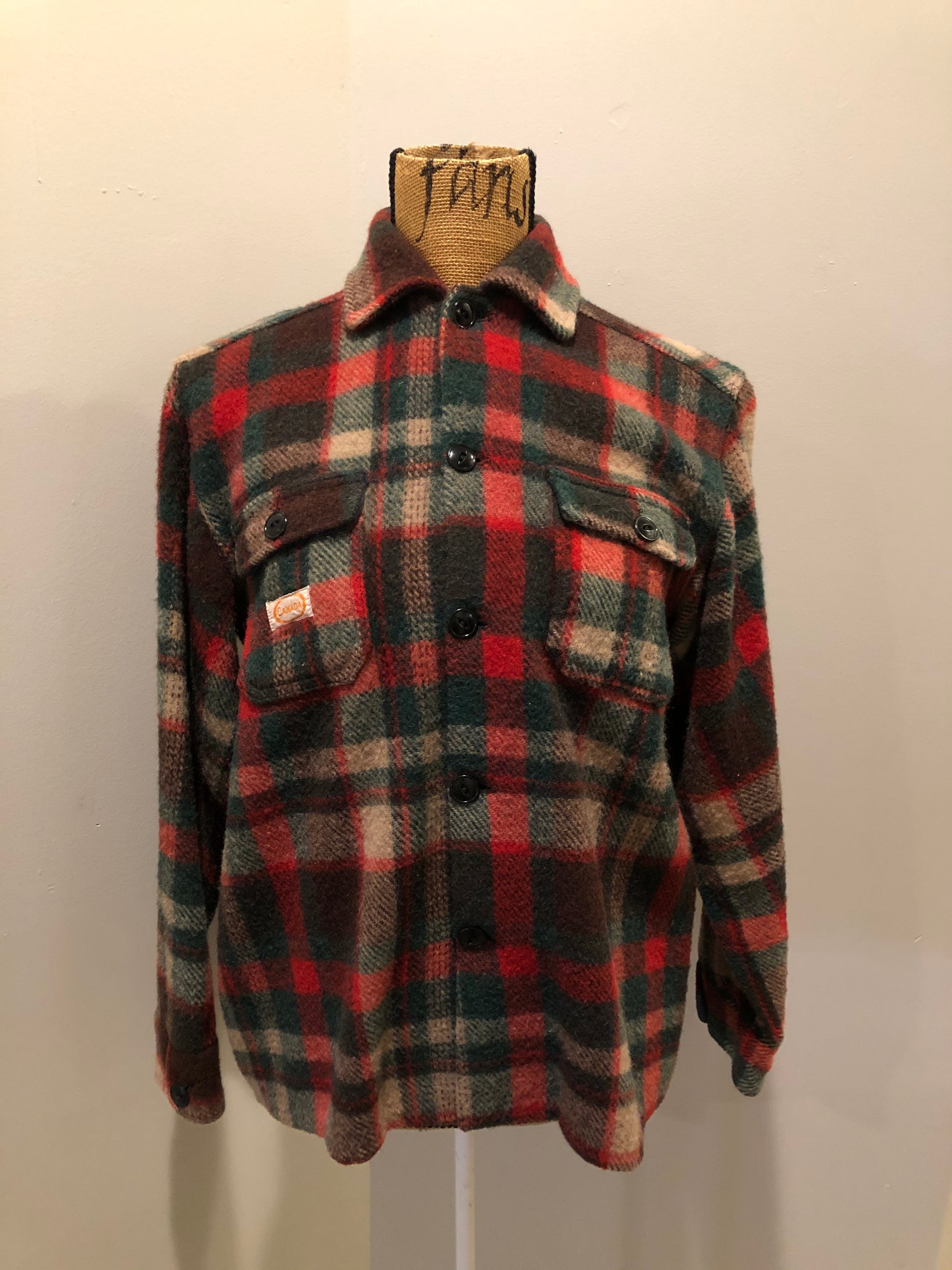 Kingspier Vintage - Regent wool blend lumberjack shirt in green, brown and red plaid with button closures and two flap pockets on the chest. Made in Canada.