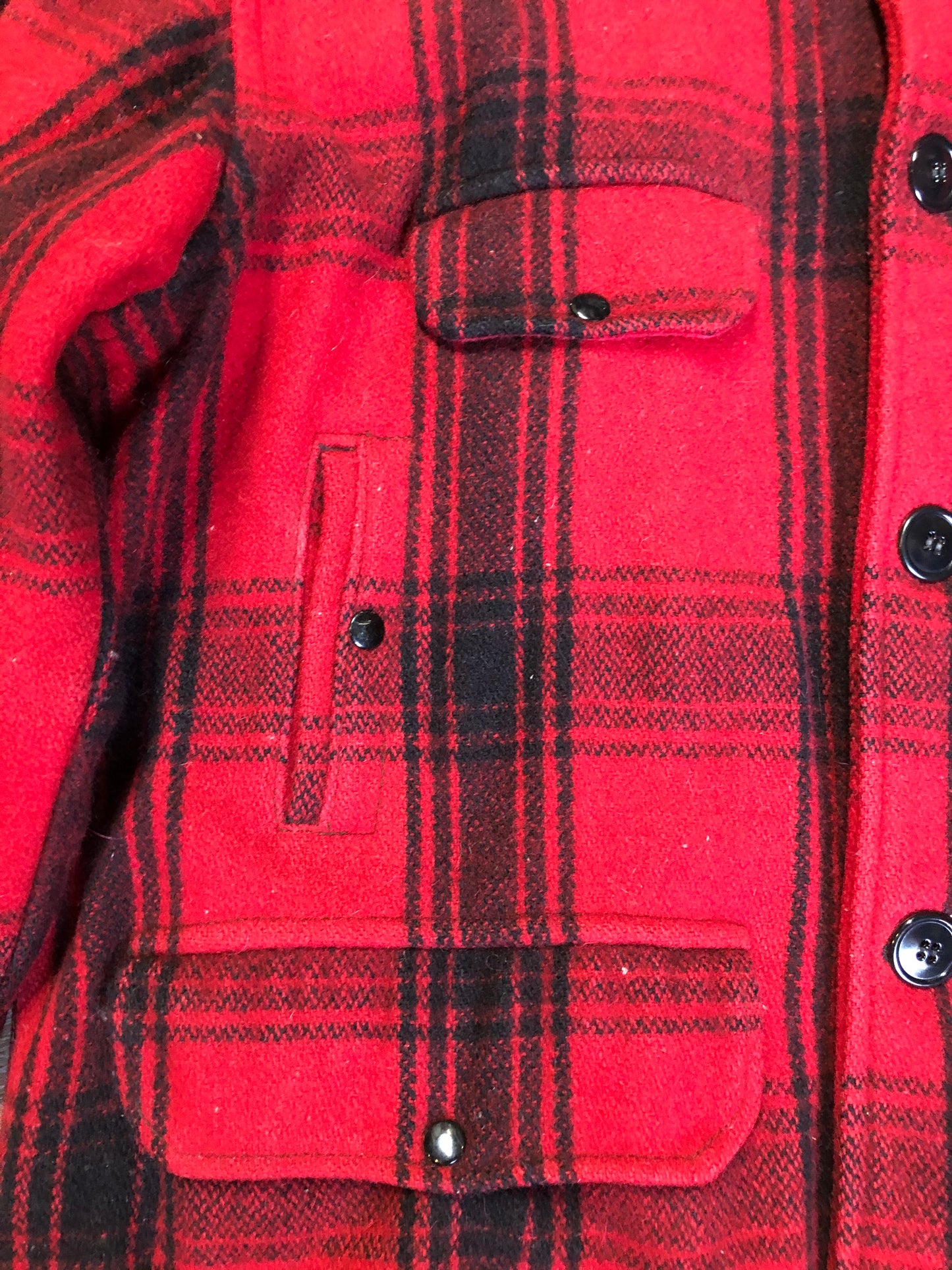 Kingspier Vintage - Johnson Woolen Mills red plaid wool hunting jacket with button closures, inside knit cuffs to keep cold air out, four flap pockets, two hand warming pockets, two side zip pockets and one inside pocket.