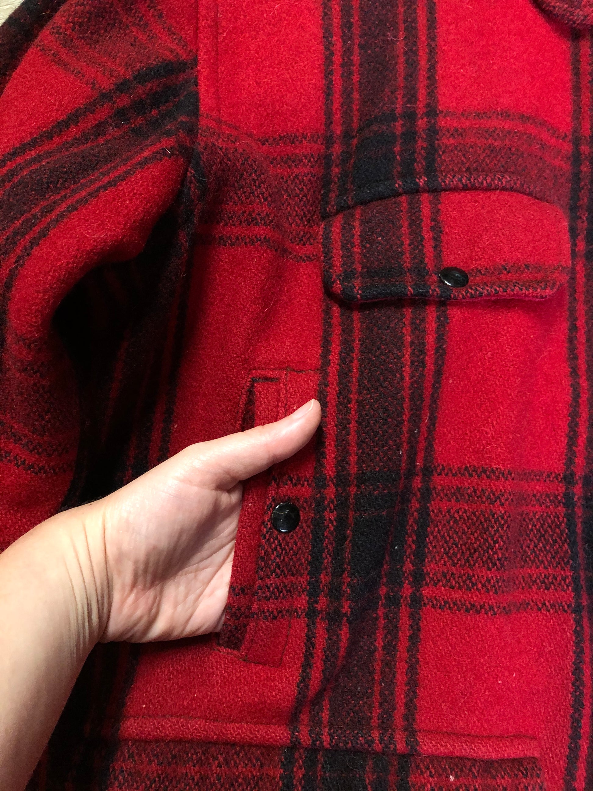 Kingspier Vintage - Johnson Woolen Mills red plaid wool hunting jacket with button closures, inside knit cuffs to keep cold air out, four flap pockets, two hand warming pockets, two side zip pockets and one inside pocket.