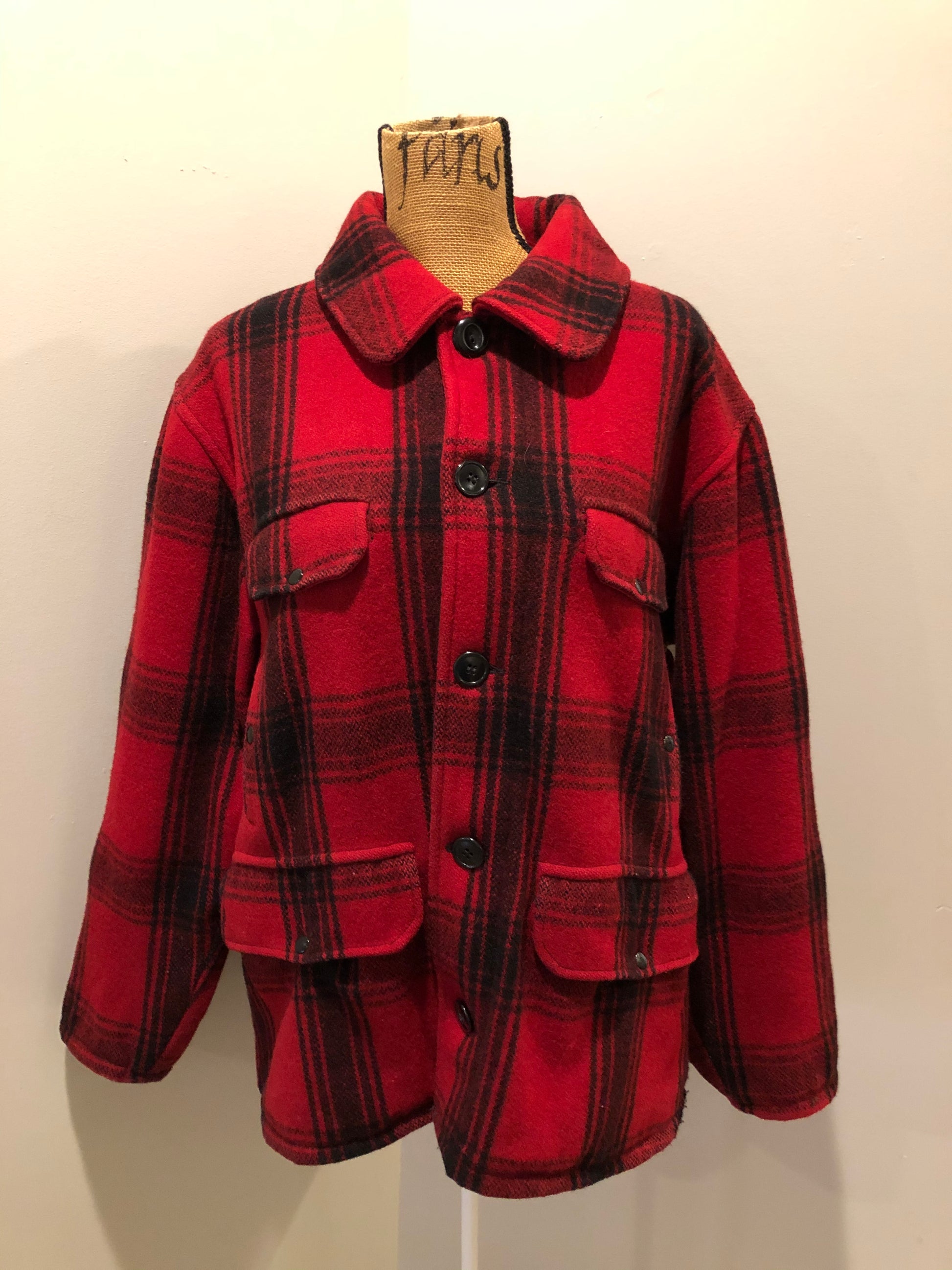 Kingspier Vintage - Johnson Woolen Mills red plaid wool hunting jacket with button closures, inside knit cuffs to keep cold air out, four flap pockets, two hand warming pockets, two side zip pockets and one inside pocket.