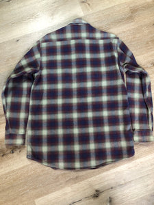 Kingspier Vintage - Herman Survivor faded blue red and green plaid lumberjack shirt with button closures and two flap pockets on the chest. Size large.