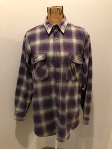 Kingspier Vintage - Herman Survivor faded blue red and green plaid lumberjack shirt with button closures and two flap pockets on the chest. Size large.