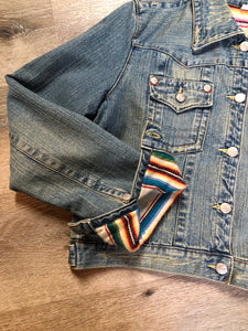 Kingspier Vintage - Younique denim jacket in a distressed light wash with colourful striped wool blend lining, button closures and two flap pockets. Size large, fits more like a medium.