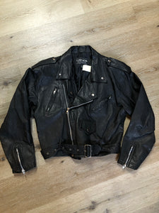 Kingspier Vintage - Cosa Nova black leather motorcycle jacket with two slash pockets, one flap pocket and a belt at the waist. Made in Canada. Size large.