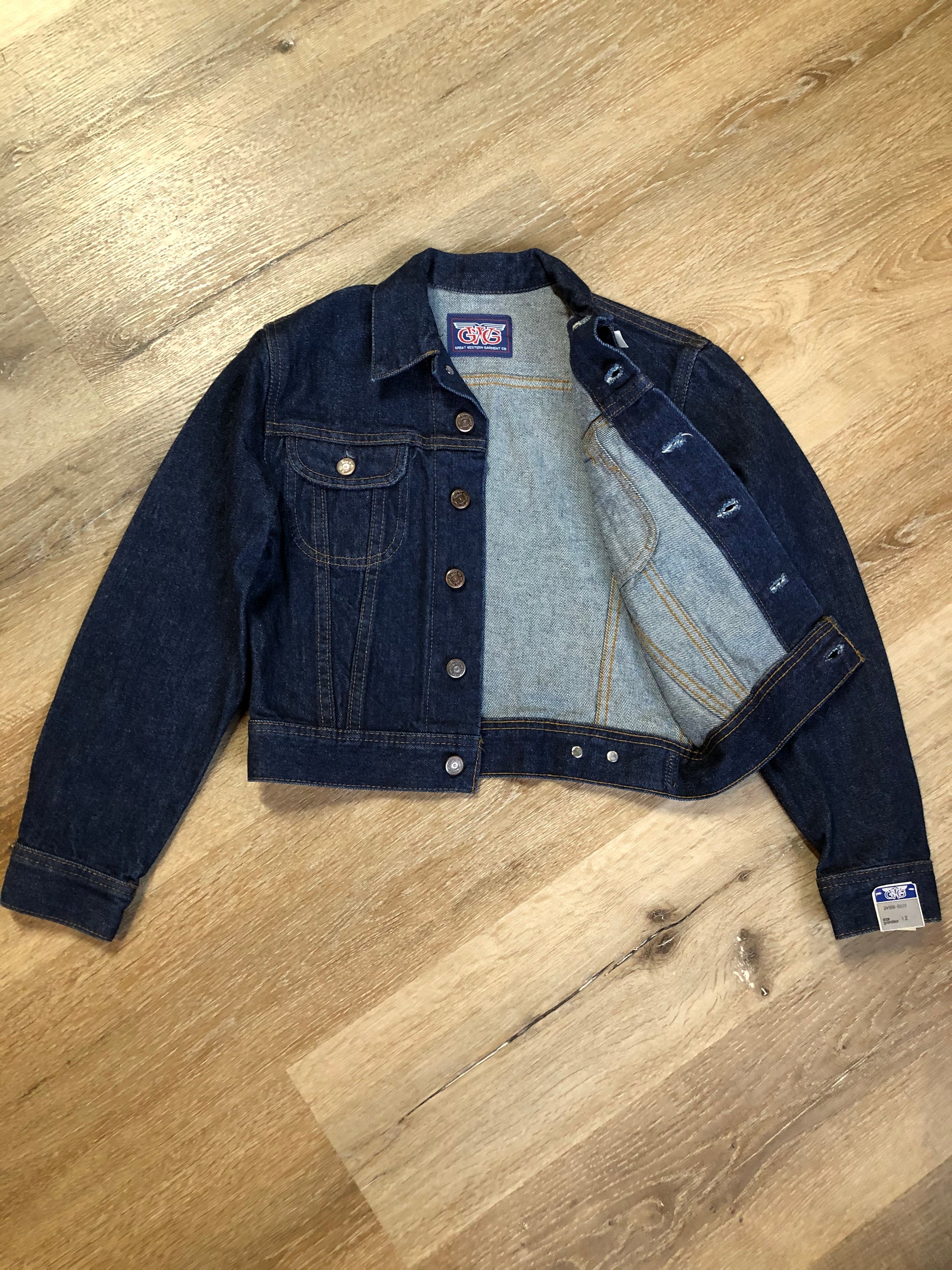 Kingspier Vintage - GWG (Great Western Garment Co.) denim jacket in a dark wash with button closures and two flap pockets on the chest. Fits XS.