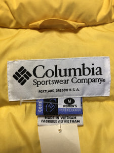Kingspier Vintage - Columbia down filled puffer vest in yellow with zipper closure, vertical zip pockets, inside pocket and drawstring at the bottom hem. Size medium.