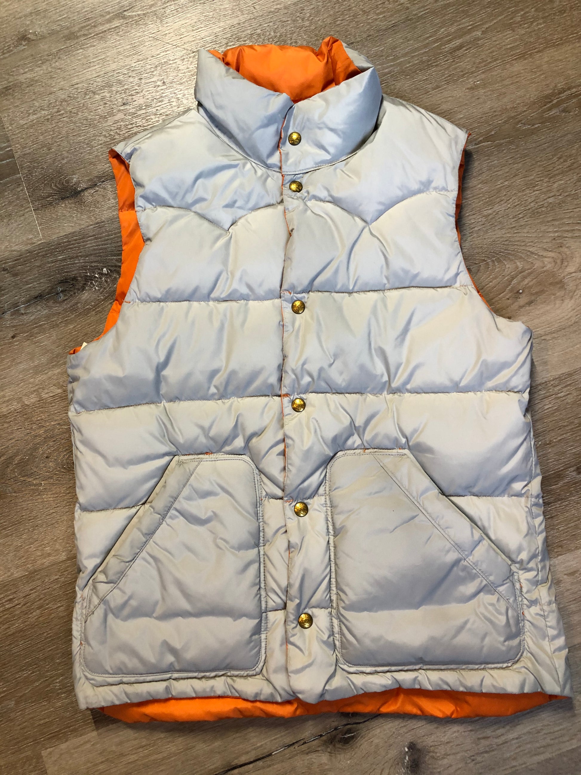 Kingspier Vintage - Scotch and Soda reversible orange and grey 1970’s down filled puffer vest with snap closures and patch pockets. Made in Amsterdam.Scotch and Soda reversible orange and grey 1970’s down filled puffer vest with snap closures and patch pockets. Made in Amsterdam.