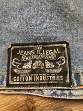Load image into Gallery viewer, Kingspier Vintage - The Jeans Illegal Trademark denim vest with button closures and two flap pockets on the chest. Size medium.
