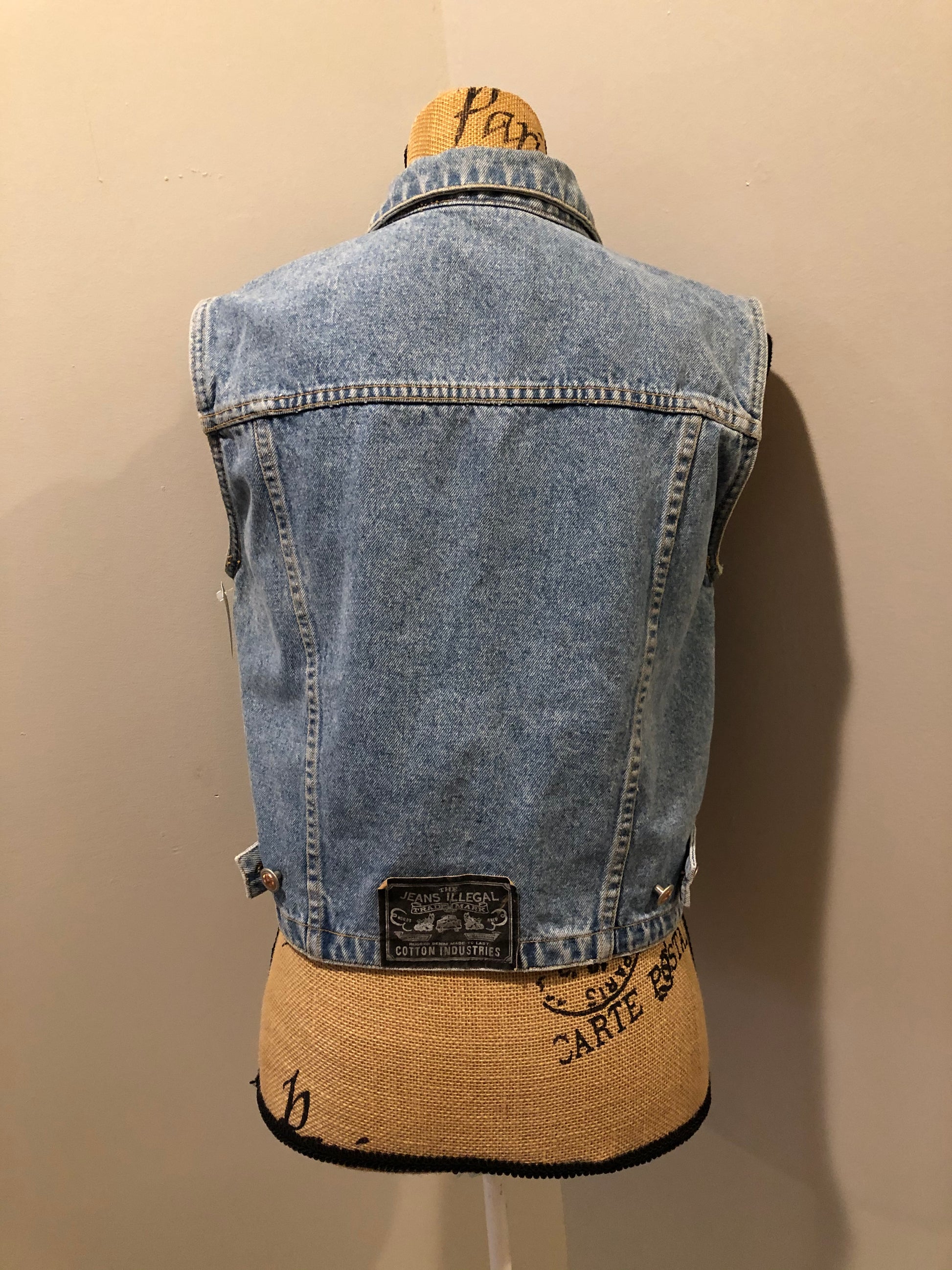 Kingspier Vintage - The Jeans Illegal Trademark denim vest with button closures and two flap pockets on the chest. Size medium.