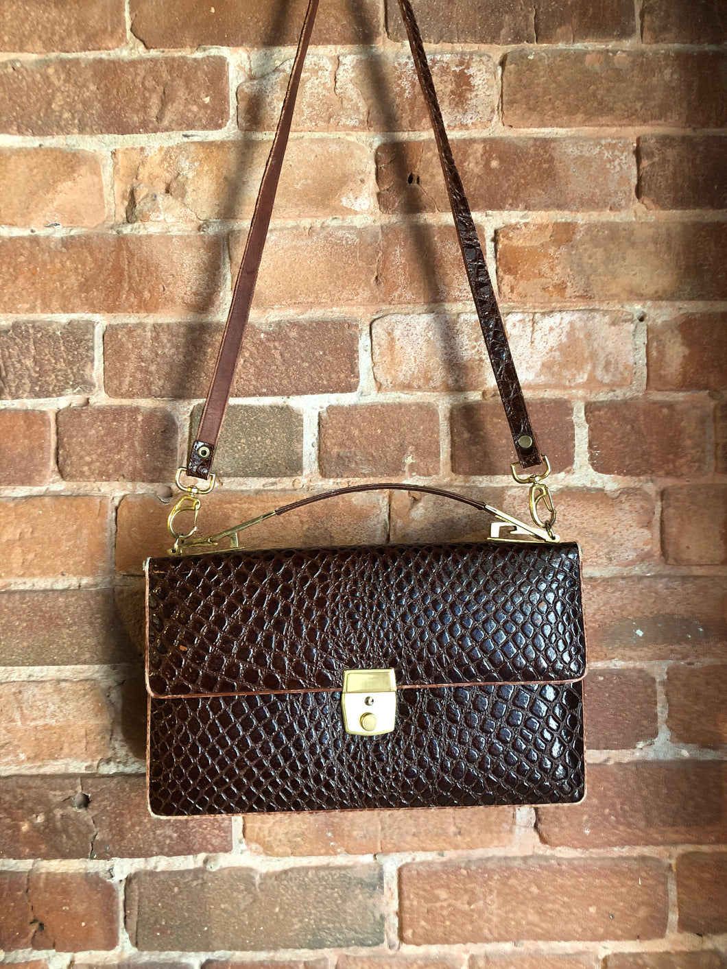 Kingspier Vintage - Dark brown reptile handbag with top handle, brass hardware, push button front clasp, detachable shoulder strap, inside pockets and leather lining.