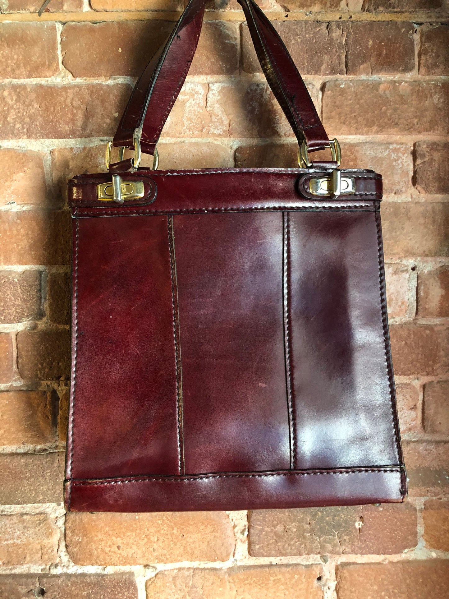 Kingspier Vintage - Caggiano deep red calfskin leather purse with brass hardware, two buckles on each side to allow the top to open fully, inside dividers and pockets. Made in Italy.