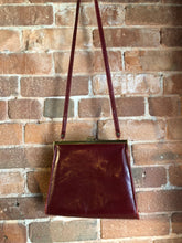 Load image into Gallery viewer, Kingspier Vintage - Deep red leather handbag circa 1950’s with brass metal details and clasp.
