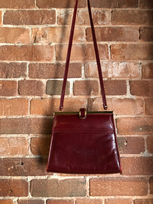 Kingspier Vintage - Deep red leather handbag circa 1950’s with brass metal details and clasp.