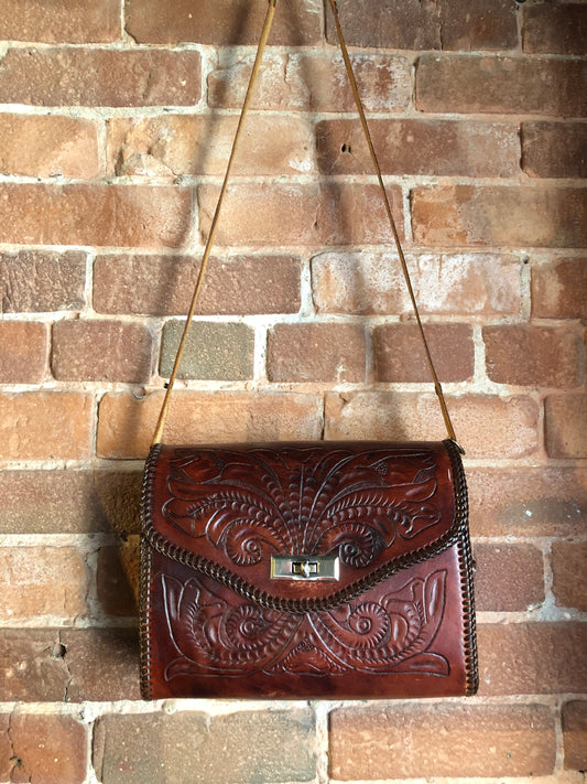 Kingspier Vintage - Hand tooled brown leather purse with leather stitching around the trim and a red leather flower motif lining.