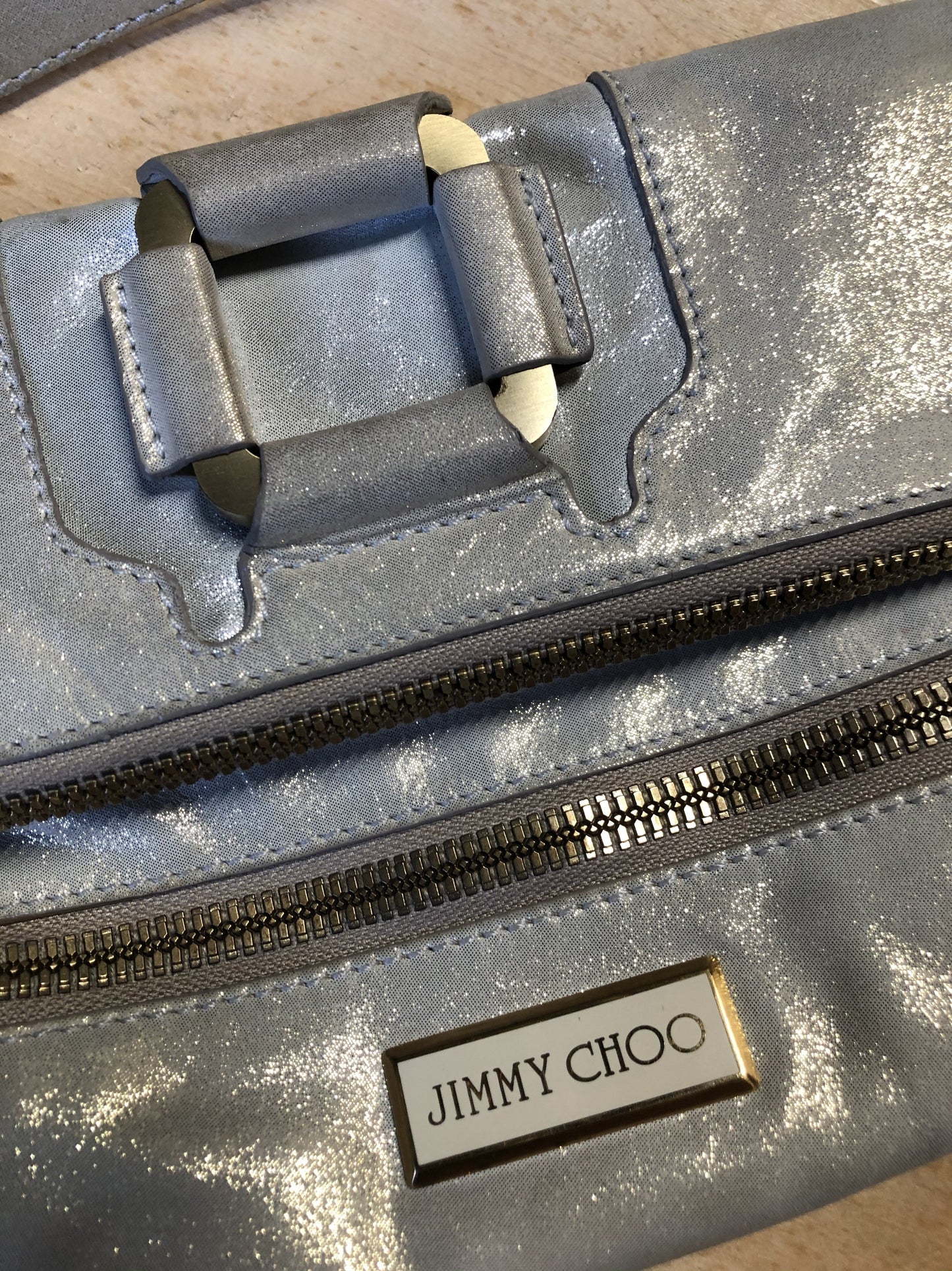 Kingspier Vintage - Authentic Jimmy Choo Mave foldover clutch in Iridescent white calfskin leather with gold hardware, suede lining, magnetic snap and zip closures.