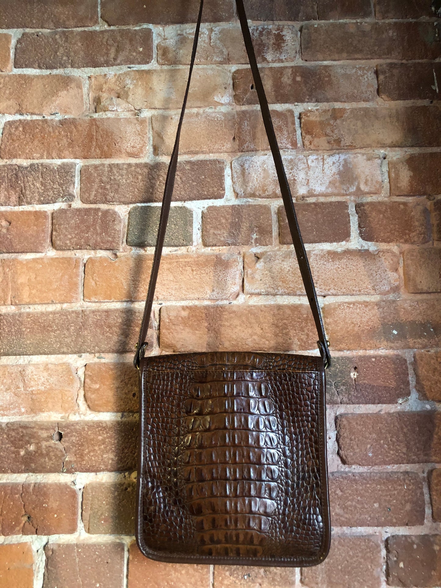 Kingspier Vintage - Brahmin croc-embossed leather crossbody handbag in pecan brown. This bag features brass hardware, snap buckle closure, back pocket and inside zip pocket. Made in the USA.