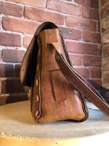 Kingspier Vintage - Hand tooled leather saddle bag with leather stitching, adjustable strap and brass front clasp.