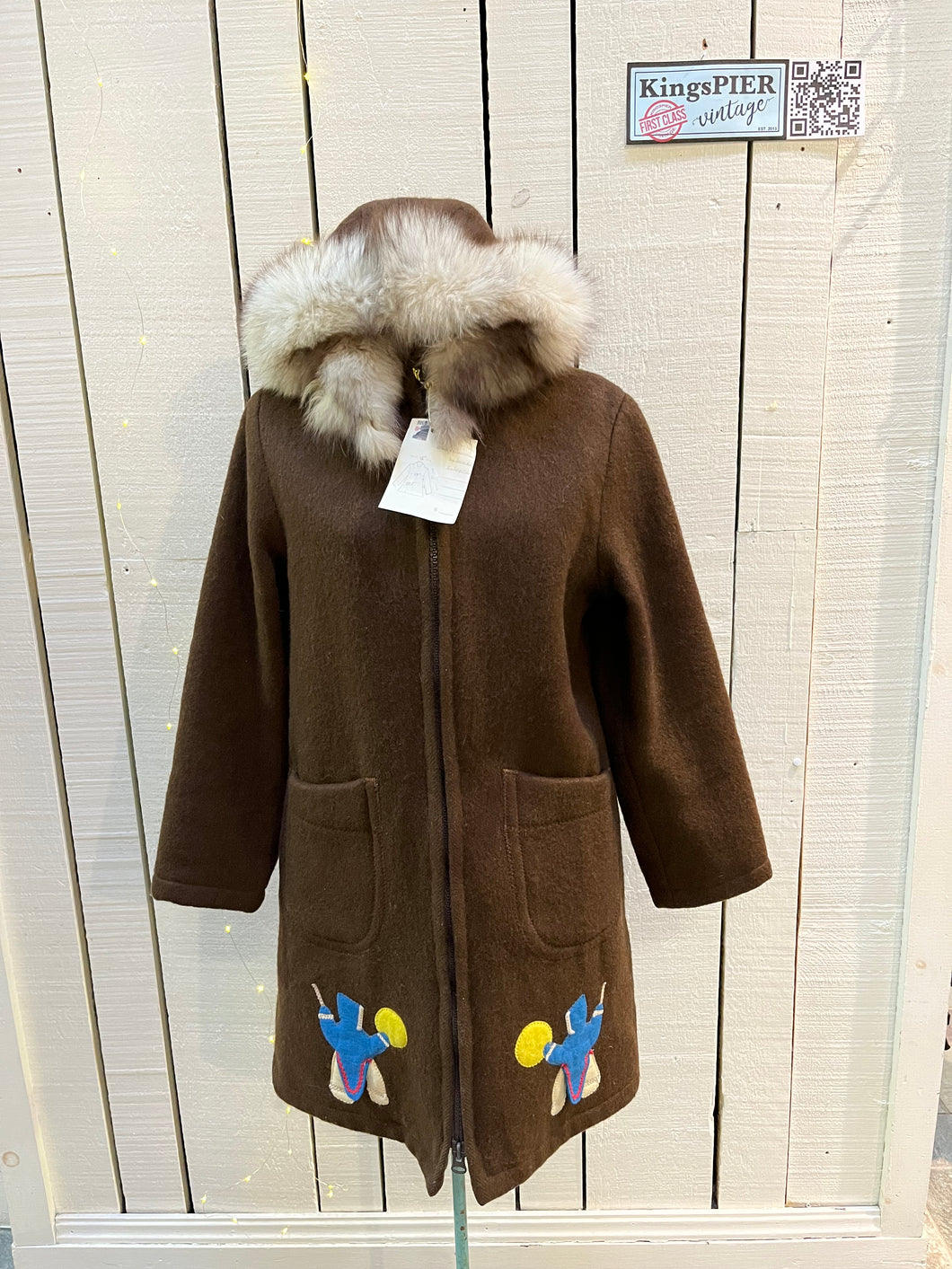 Vintage Inuvik Enterprise brown 100% pure virgin wool northern parka with zipper closure, front pockets, fur trimmed hood and felt applique in a drumming motif.

Made in Canada
Chest 38”