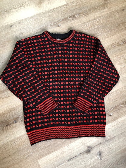 Kingspier Vintage - Hand knit black and red heritage print wool sweater. Made in Canada. Size L/XL.