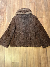 Load image into Gallery viewer, Vintage Brunswick Furriers brown persian lamb jacket with fur collar, two front pockets, flower decorated button closures and a “N.G.S” monogram on the inside lining.

Made in Canada, Chest 38”
