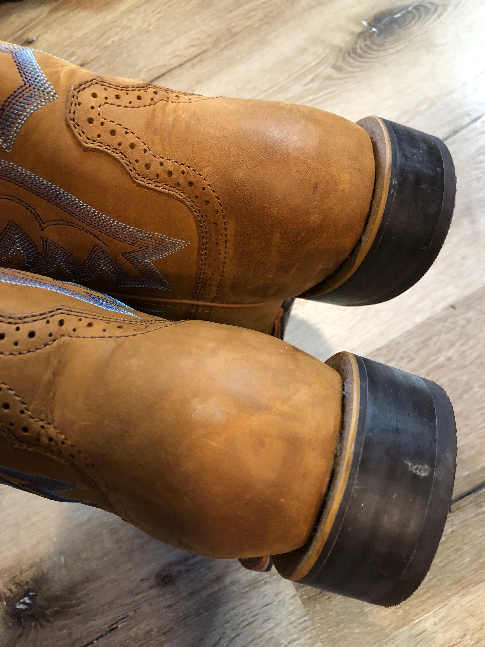 Twisted leather light brown cowboy boots with blue decorative stitching, leather lined with synthetic soles.  Size 10M, 12W US/ 43 EUR