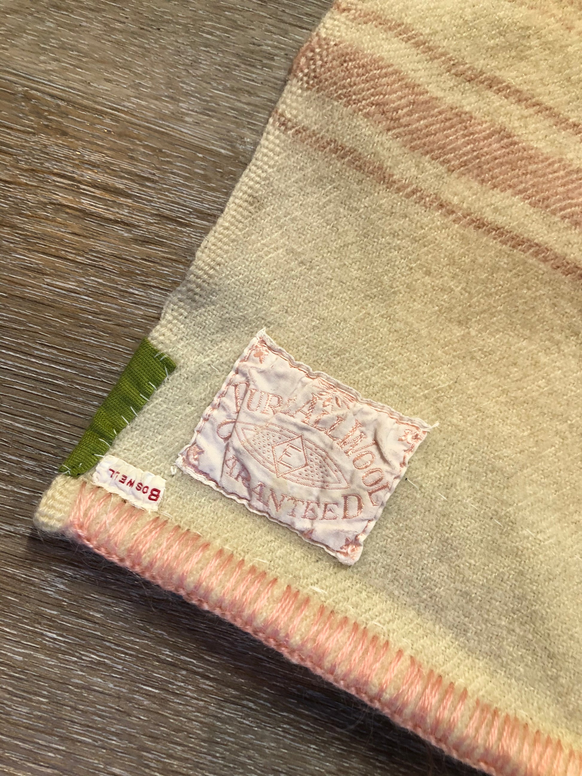 Kingspier Vintage - Vintage Boswell beige and pink stripe wool lap blanket with green reinforcement on the back of the ribbon.