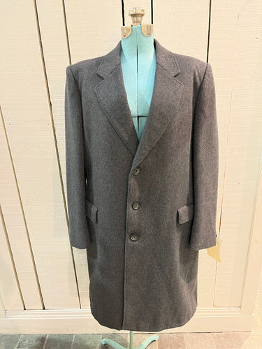 Vintage Moores wool blend long grey coat (65% wool/ 15% cashmere/ 15% polyester/ 5% other) with button closures, two front pockets and two inside pockets.

Made in Canada
Chest 42”