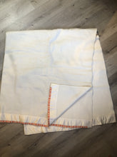 Load image into Gallery viewer, Kingspier Vintage - White 100% wool blanket with white ribbon trim on one end and a red, yellow and orange striped ribbon on the other end.
Fits a double bed.


